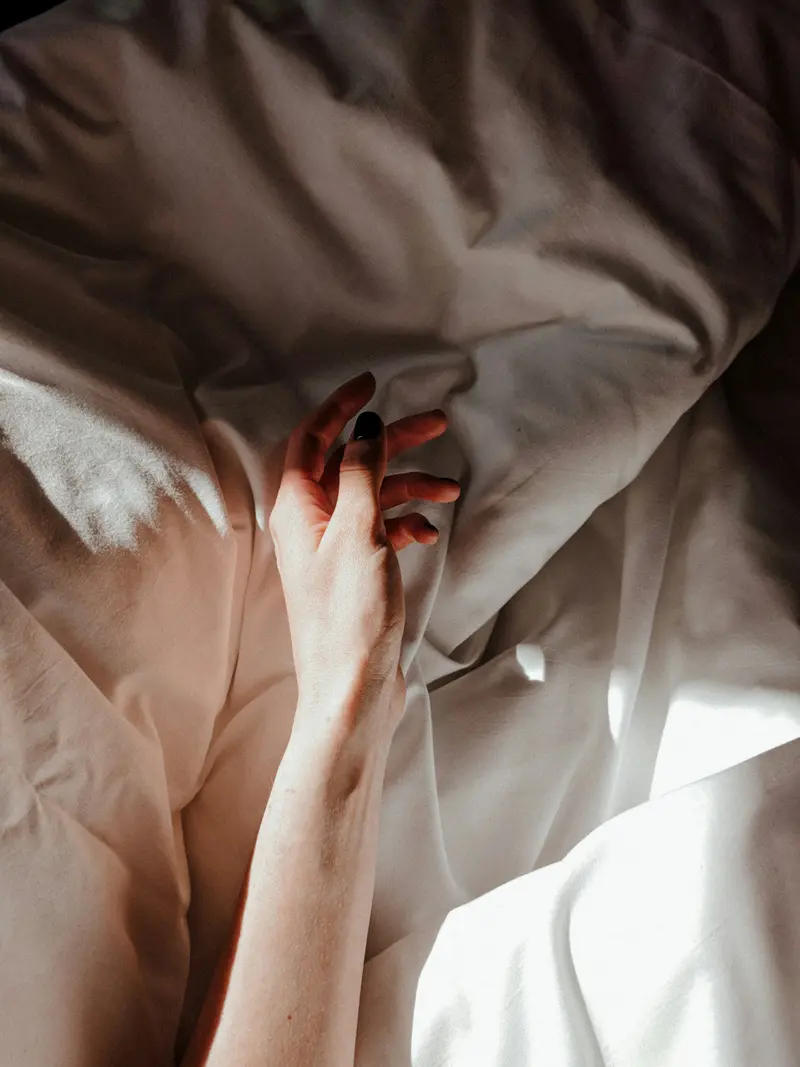 Main lissant délicatement un drap blanc en coton